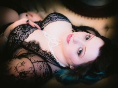 woman in black lace gown laying on back for a Boudoir Photograph