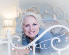 woman wearing a blue jumper for a boudoir photoshoot