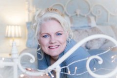 woman wearing a blue jumper for a boudoir photoshoot