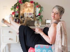 woman in black dress holding gin and tonic for a Boudoir Photograph Lincolnshire