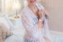 woman on bed in white lace gown Boudoir Photography Lincolnshire