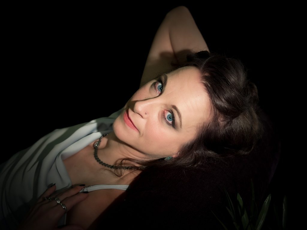 mature woman lying on a couch for boudoir photograph