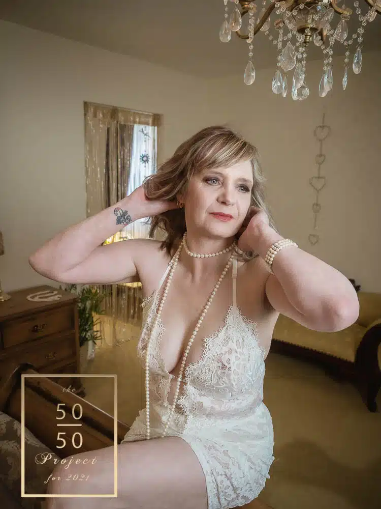 woman in white bodysuit having a boudoir shoot for mature ladies