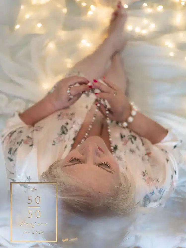 mature woman lying on a couch for boudoir photograph