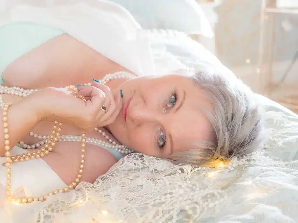 mature women boudoir wearing pearls and lace for the 50 over 50 project