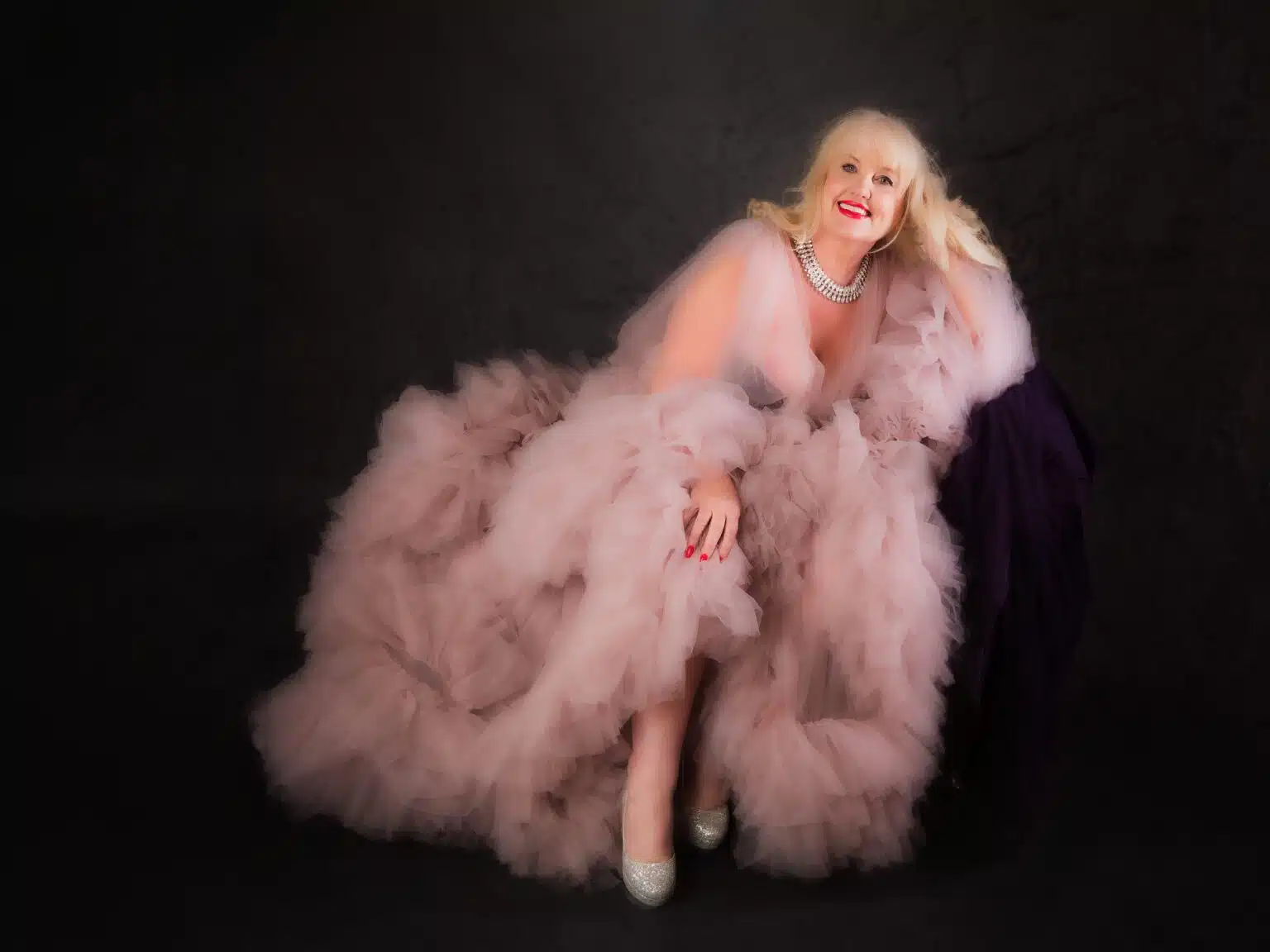 mature woman in pink boudoir robe