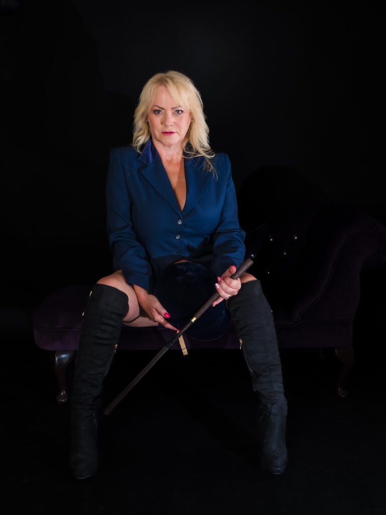 mature woman in riding boots boudoir photo