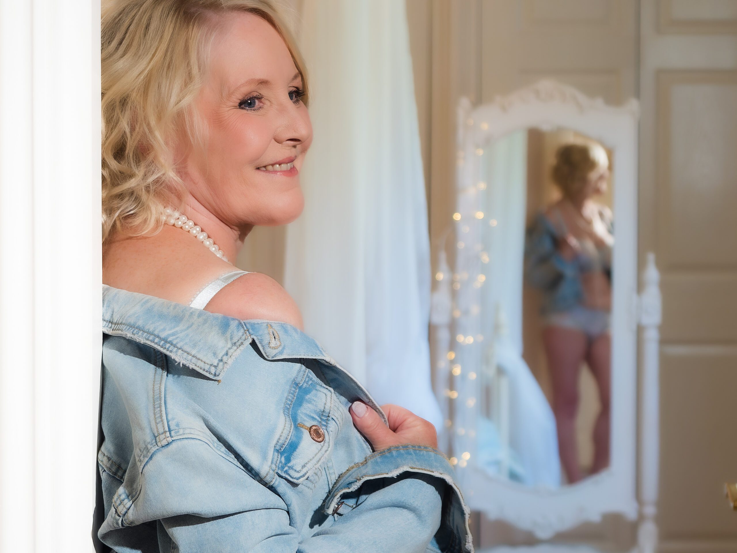 mature woman reflected in mirror for boudoir photoshoot