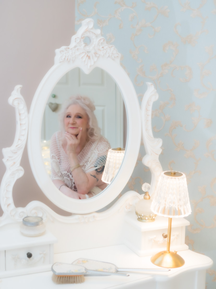 woman looking in boudoir mirror