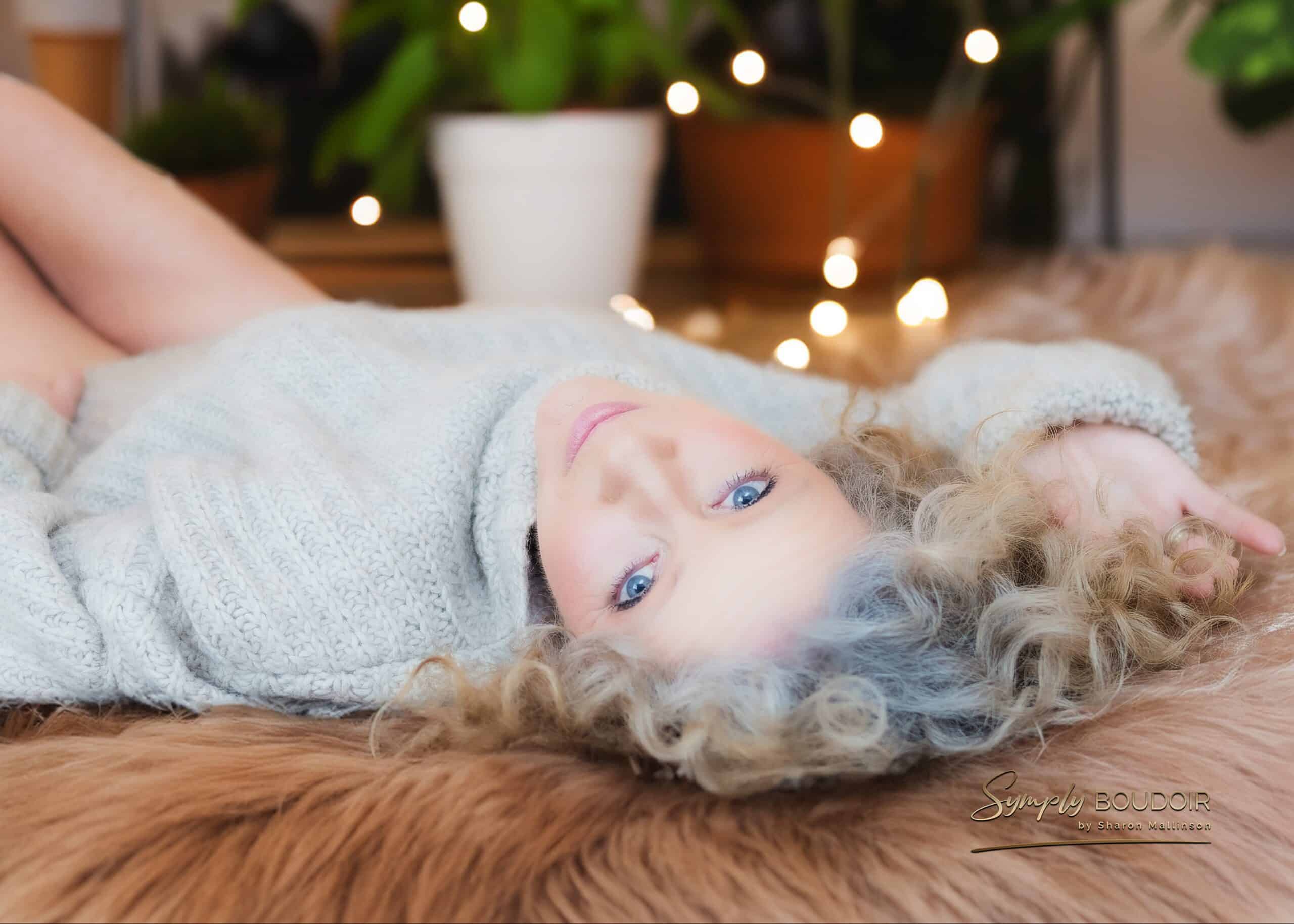 mature woman lying on bed for a boudoir photoshoot