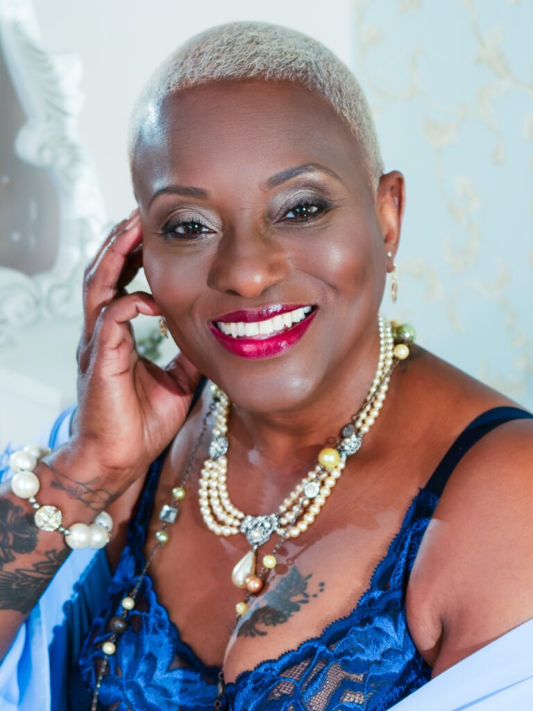 mature lady of colour sat at dressing table for boudoir photo shoot