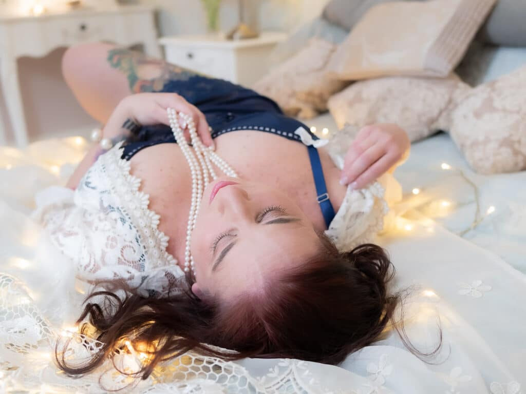 woman in lace robe lying on bed