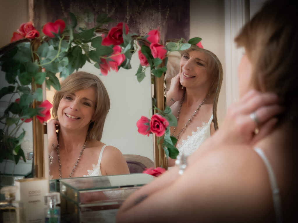 Symply Boudoir woman smiling in mirror with rose decoration