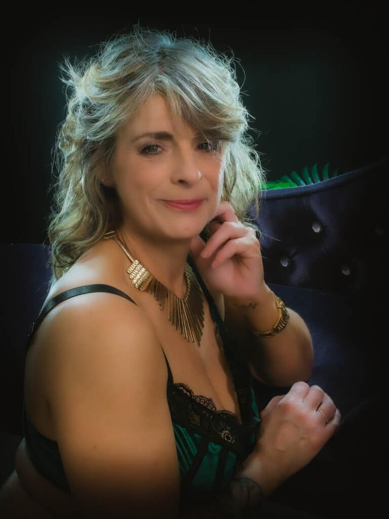 mature woman leaning on boudoir chair