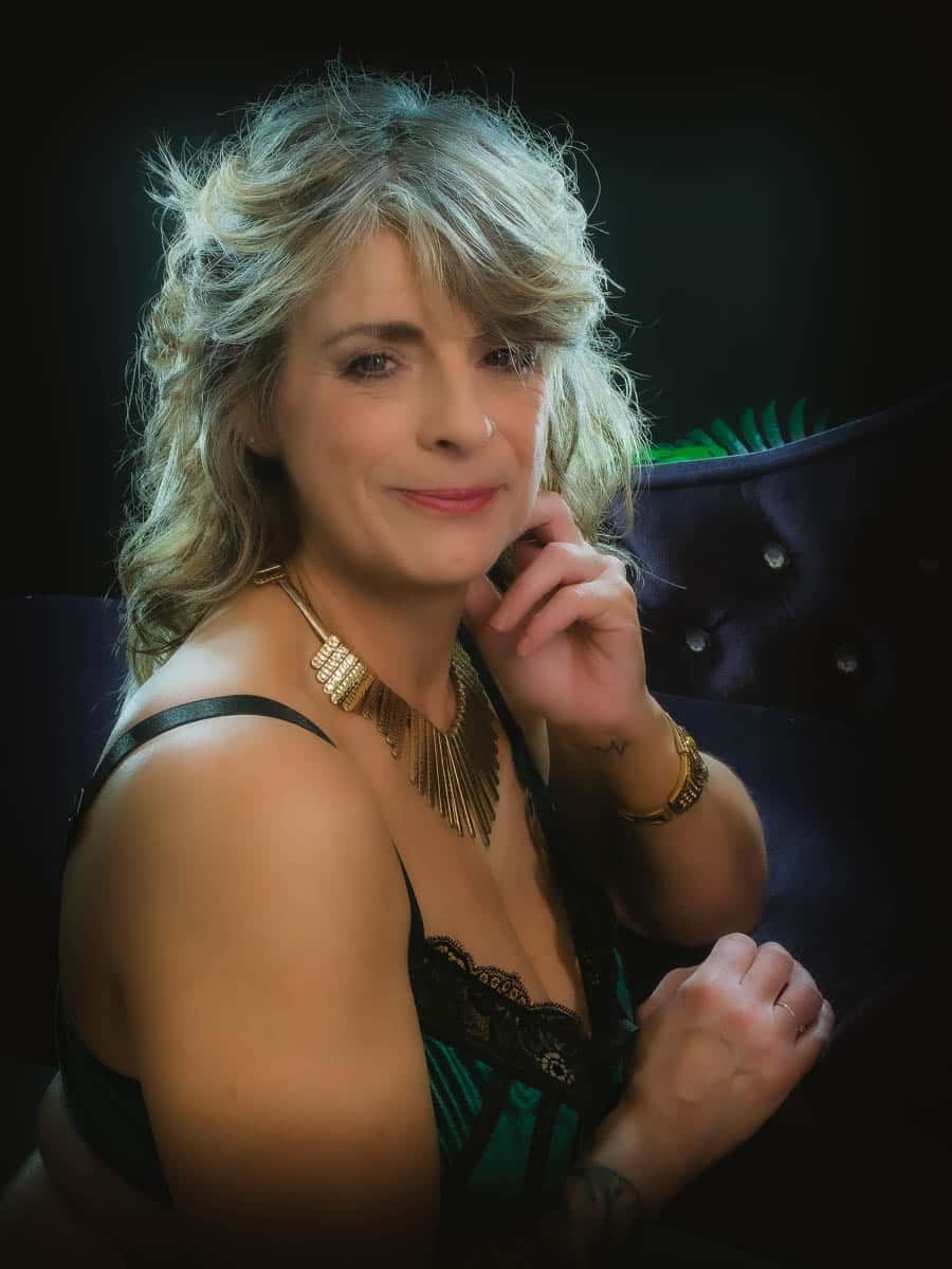 mature woman leaning on boudoir chair